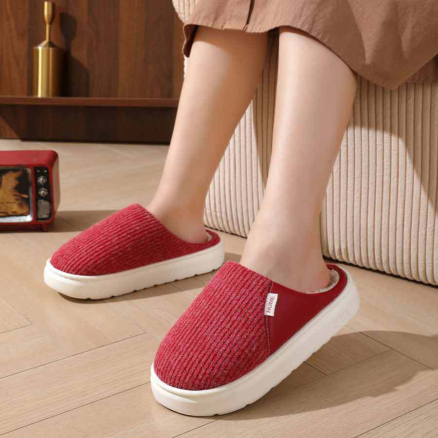 Red plush slippers worn